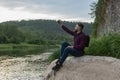 young man using cellphone, bearded hipster traveler doing selfie. Vacation, tourism, internet, technology concept Royalty Free Stock Photo