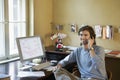 Young man Using Cellphone In Office Royalty Free Stock Photo