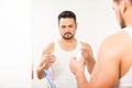 Young man using dental floss in the bathroom Royalty Free Stock Photo