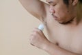 Young man using a deodorant Royalty Free Stock Photo
