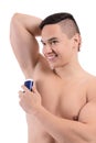 Young man using deodorant on white background Royalty Free Stock Photo