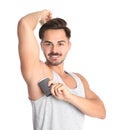 Young man using deodorant Royalty Free Stock Photo