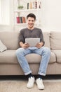 Young man using digital tablet at home Royalty Free Stock Photo