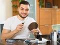 Young man using hair trimmer Royalty Free Stock Photo