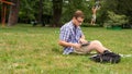 Young man using his laptop on the grass. Royalty Free Stock Photo