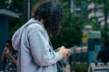 young Man using his Mobile Phone outdoor, close up view. Young guy sending a sms with his mobile phone Royalty Free Stock Photo