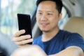 Young man using his smartphone behind the wheel Royalty Free Stock Photo