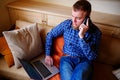 Young man using his smartphone for online banking - sitting on s Royalty Free Stock Photo