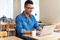 Young man using laptop at cafe Royalty Free Stock Photo