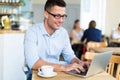 Young man using laptop at cafe Royalty Free Stock Photo
