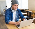 Young man using laptop at cafe Royalty Free Stock Photo
