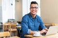 Young man using laptop at cafe Royalty Free Stock Photo