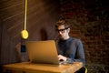 Young man using laptop in coffee shop with a cup of coffee