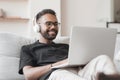 Young man using laptop computer at home, Student men resting in his room, working from home, online meeting concept Royalty Free Stock Photo