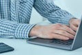 Male hands typing on laptop keyboard. Young man using laptop computer. Business working concept. Royalty Free Stock Photo