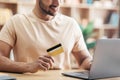 Young man using laptop and credit card while shopping online and making payment, sitting at home, closeup Royalty Free Stock Photo