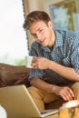 Young man using laptop on his couch Royalty Free Stock Photo