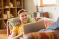 Young man using laptop on his couch Royalty Free Stock Photo