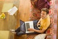 Young man using laptop on his couch Royalty Free Stock Photo