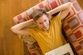 Young man using laptop on his couch Royalty Free Stock Photo