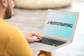 Young man using laptop at home. Bootstrap button