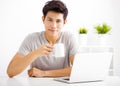 Young man using laptop in living room Royalty Free Stock Photo