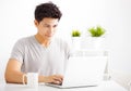 Young man using laptop in living room Royalty Free Stock Photo