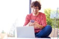 Young man using laptop and mobile phone while working at home Royalty Free Stock Photo