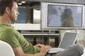 Young Man Using Laptop In Modern Apartment Royalty Free Stock Photo