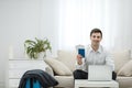 Young man using laptop to book airplane tickets or do online check-in at home. Royalty Free Stock Photo