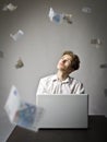 Young man with laptop. Young worker and falling Euro banknotes