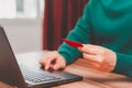 Young man using laptop to register via credit card to shop online. Royalty Free Stock Photo