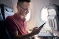 Man using mobile phone at airplane Royalty Free Stock Photo