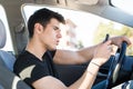 Young Man using mobile phone while driving Royalty Free Stock Photo