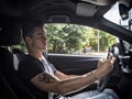 Young man using mobile phone while driving Royalty Free Stock Photo