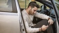 Young Man using mobile phone sitting in car Royalty Free Stock Photo