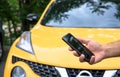 Man using mobile smart phone with car Royalty Free Stock Photo