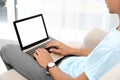 Young man using modern computer, focus on hands. Space for design