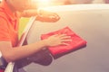 Young man using red microfiber cloth cleaning body of new silver Royalty Free Stock Photo