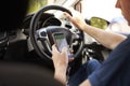 Young Man Using Satellite Navigation on Phone Whilst Driving Royalty Free Stock Photo