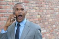 Young man using smart phone getting shocking news. Surprised businessman calling with mobile smartphone Royalty Free Stock Photo