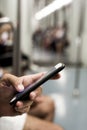 Young man using a smartphone in a or subway Royalty Free Stock Photo