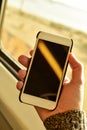 Young man using a smartphone in a train or a bus Royalty Free Stock Photo