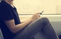 Young man using a smartphone in a train or a subway Royalty Free Stock Photo