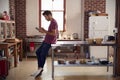 Young man using tablet computer in kitchen, full length Royalty Free Stock Photo