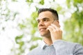 Young man using tablet & mobile phone in the park Royalty Free Stock Photo