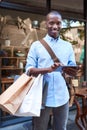 Young man using a tablet while shopping in the city Royalty Free Stock Photo