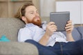 young man using tablet on sofa at home Royalty Free Stock Photo