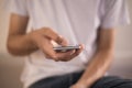 Young man using touchscreen smartphone. Concept for using technology, shopping online, using mobile apps, texting, phone addiction Royalty Free Stock Photo