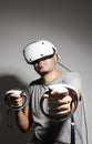Young man using VR headset. Guy playing with VR glasses Royalty Free Stock Photo